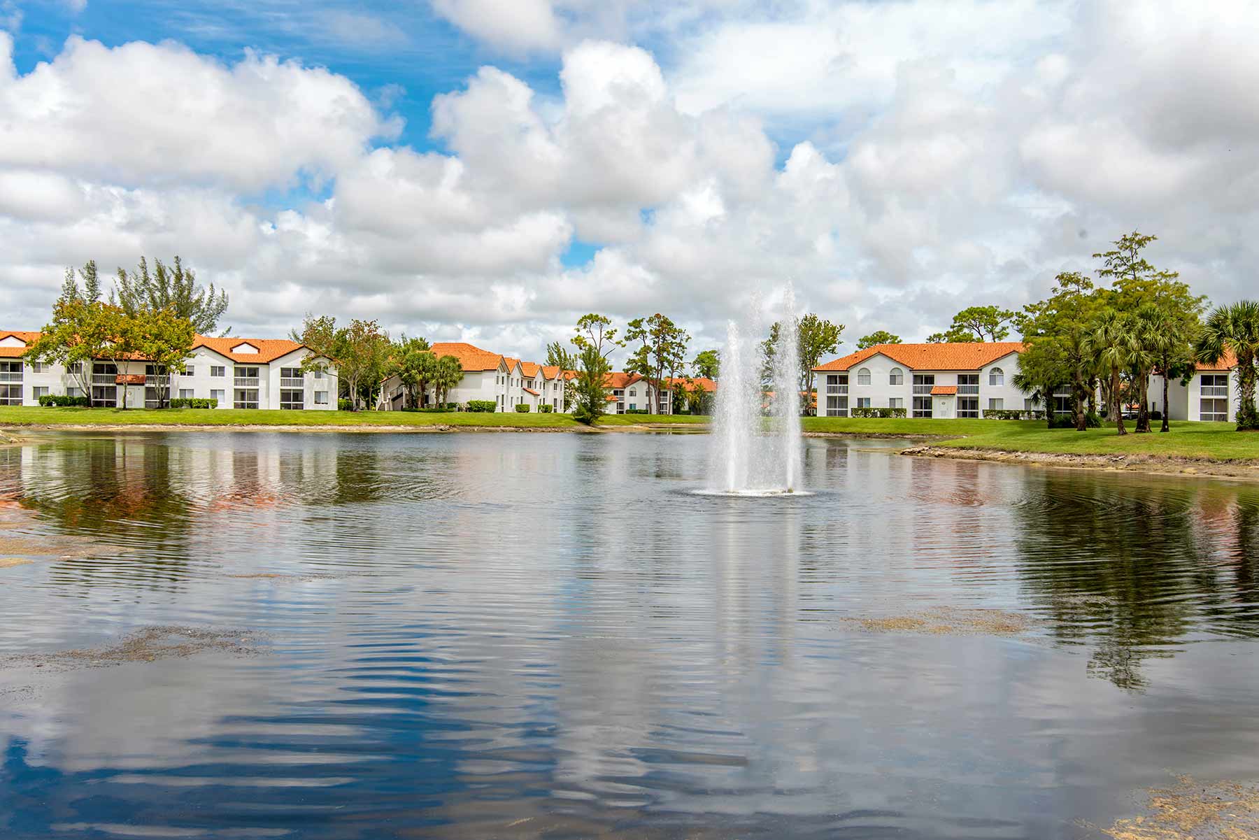 Lake with fountain surrounded by residential buildings
